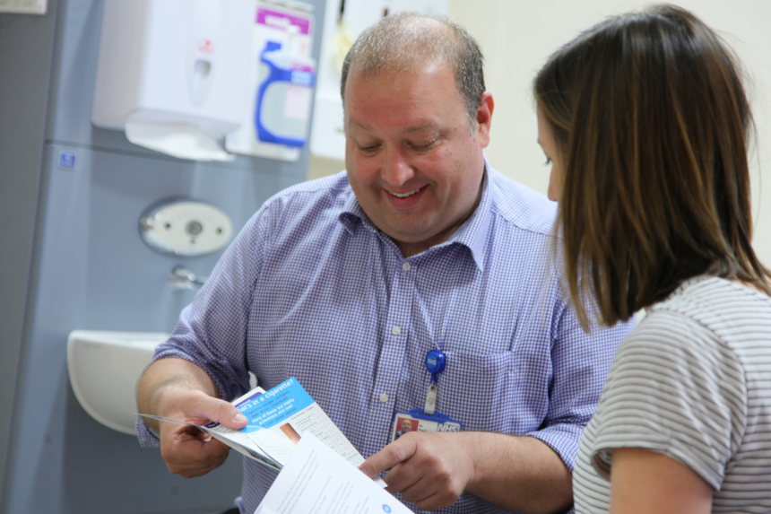 Male clinician showing smoking leaflet